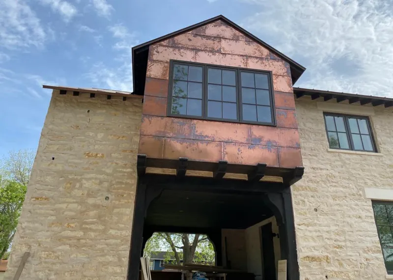 Copper metal panel facade on a stone building for Skylight Installation in San Juan Capistrano